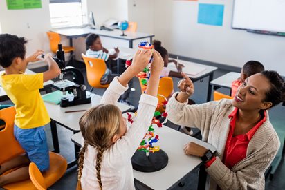 Classroom with Children bulding with blocks and other science items