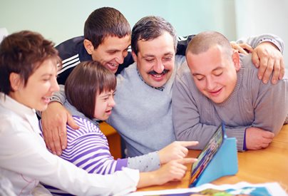 Several people looking at information on an ipad